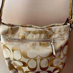 Tan and Gold Coach crossbody bag
Coach
